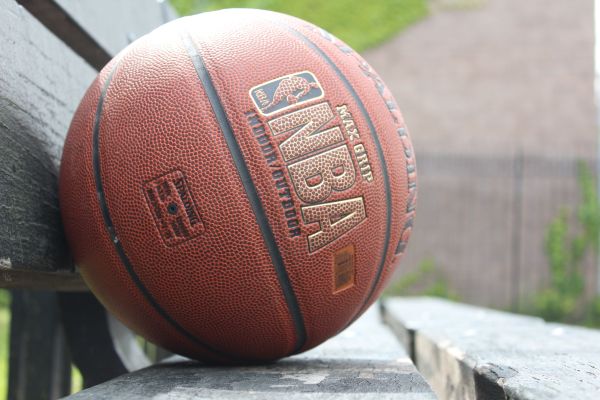 What are the key differences in coaching styles between NBA and European basketball?